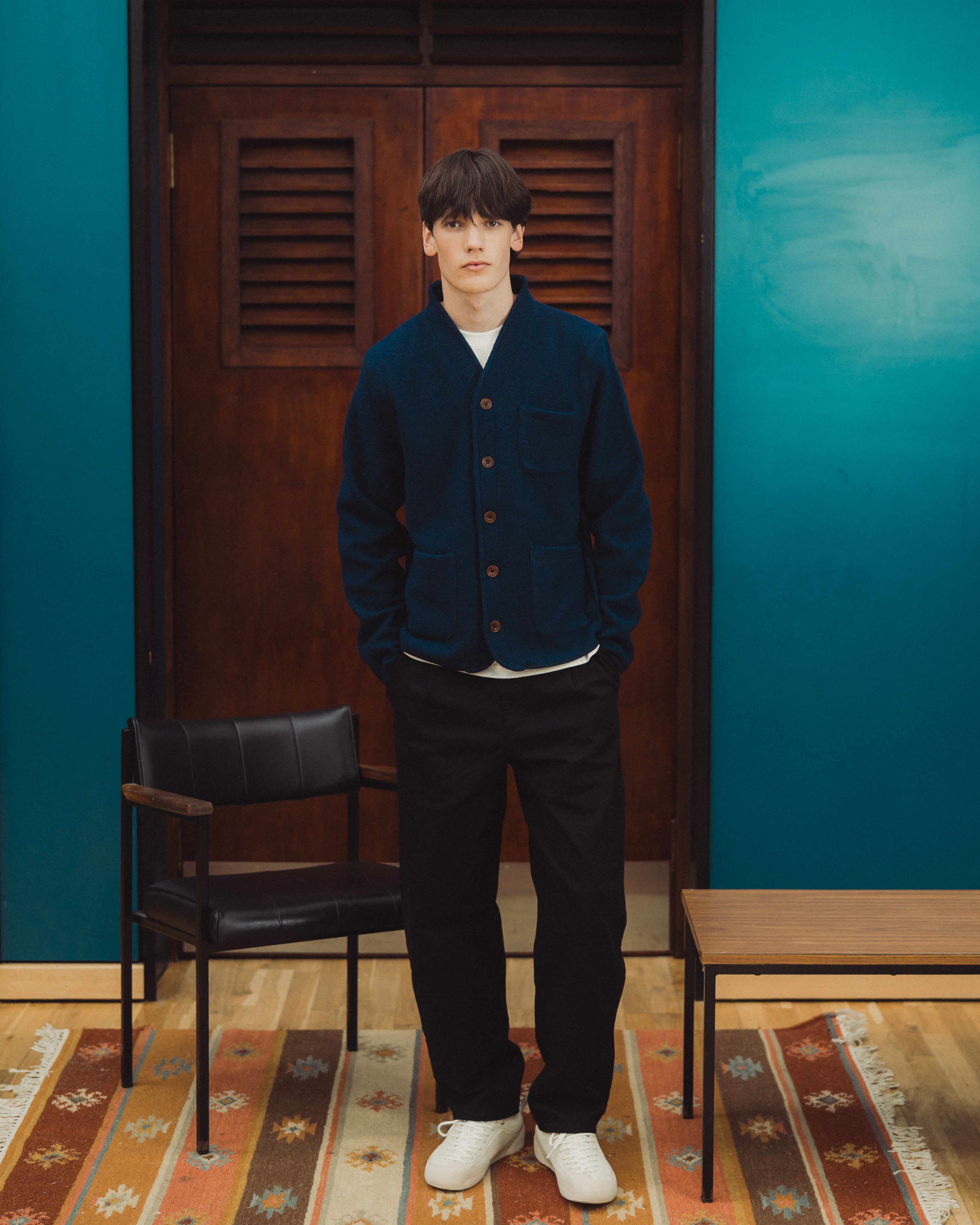 navy wool cardi, model standing in front of door