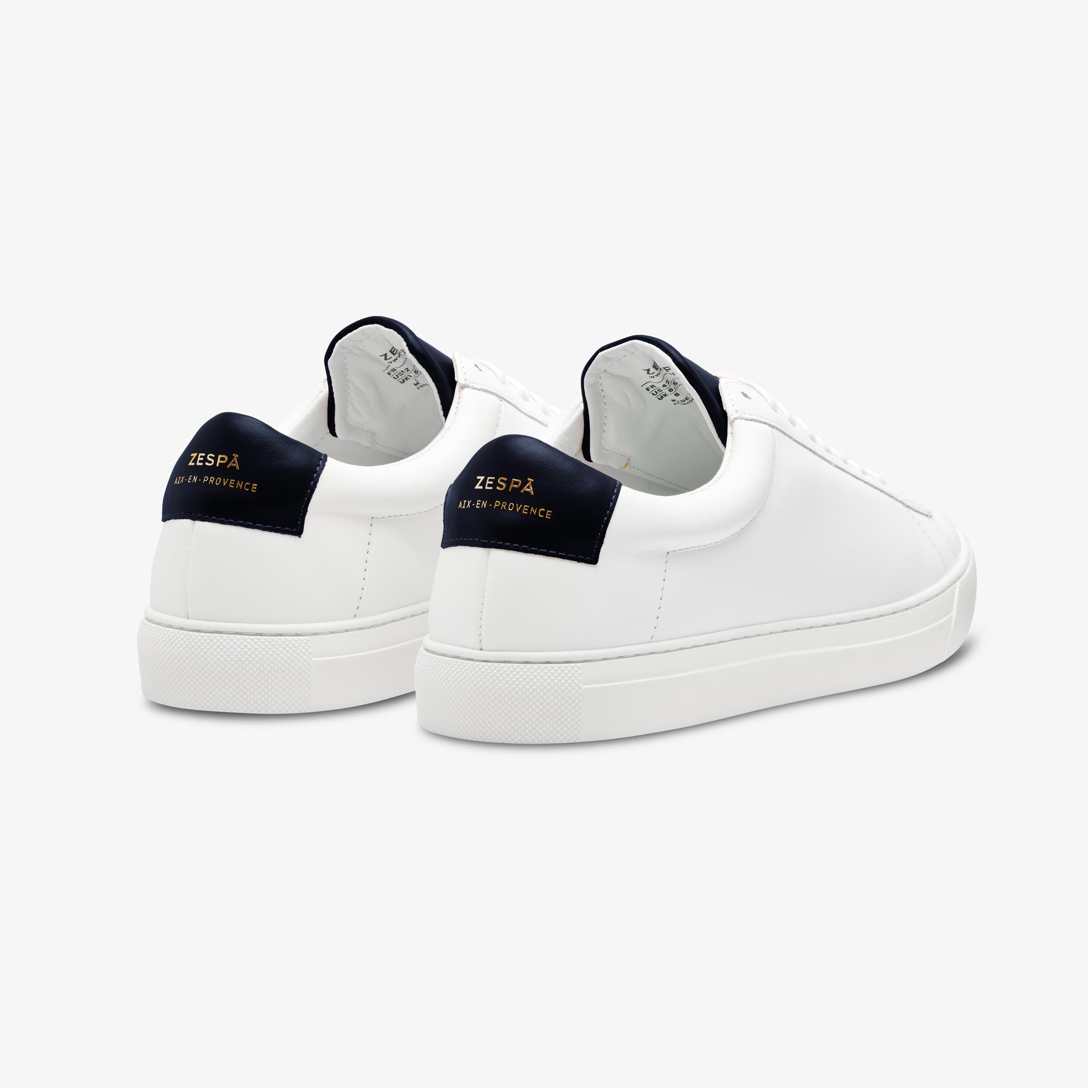 White sneakers with white soles on a white background with navy accents from Zespa