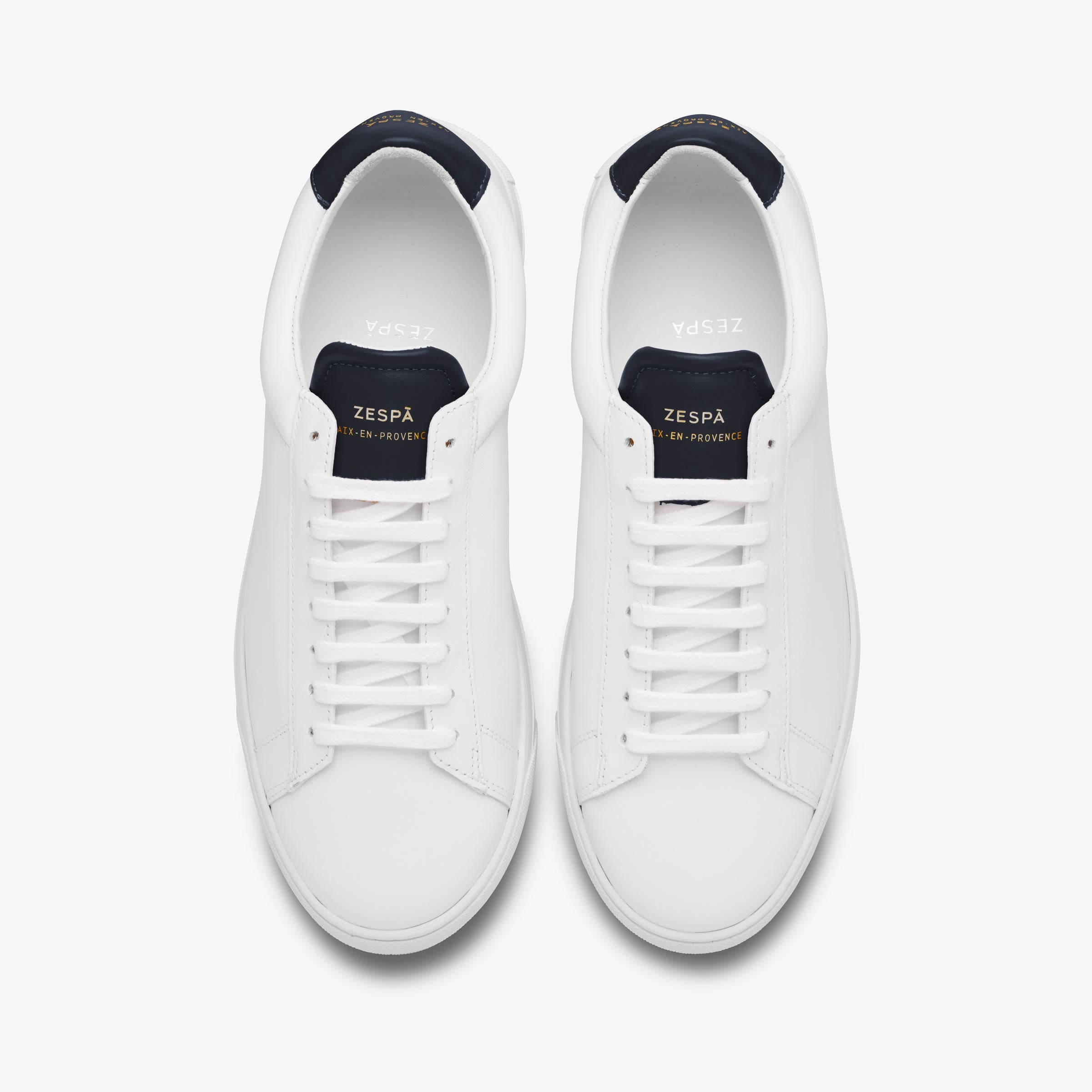 White Zespa sneakers with navy accents on a white background