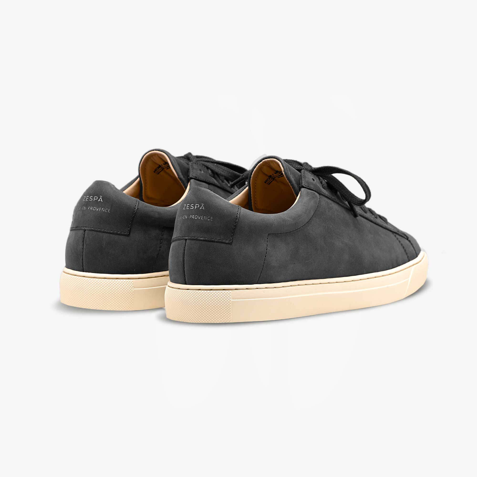 Pair of black Zespa sneakers with beige soles on a light gray background