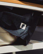 Dark blue jacket with a logo on a reflective surface