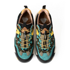 Flower Mountain Pair of teal and black sneakers with yellow laces on a white background