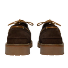 Pair of brown suede shoes with brown laces on a white background