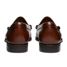 Brown leather loafers on a white background