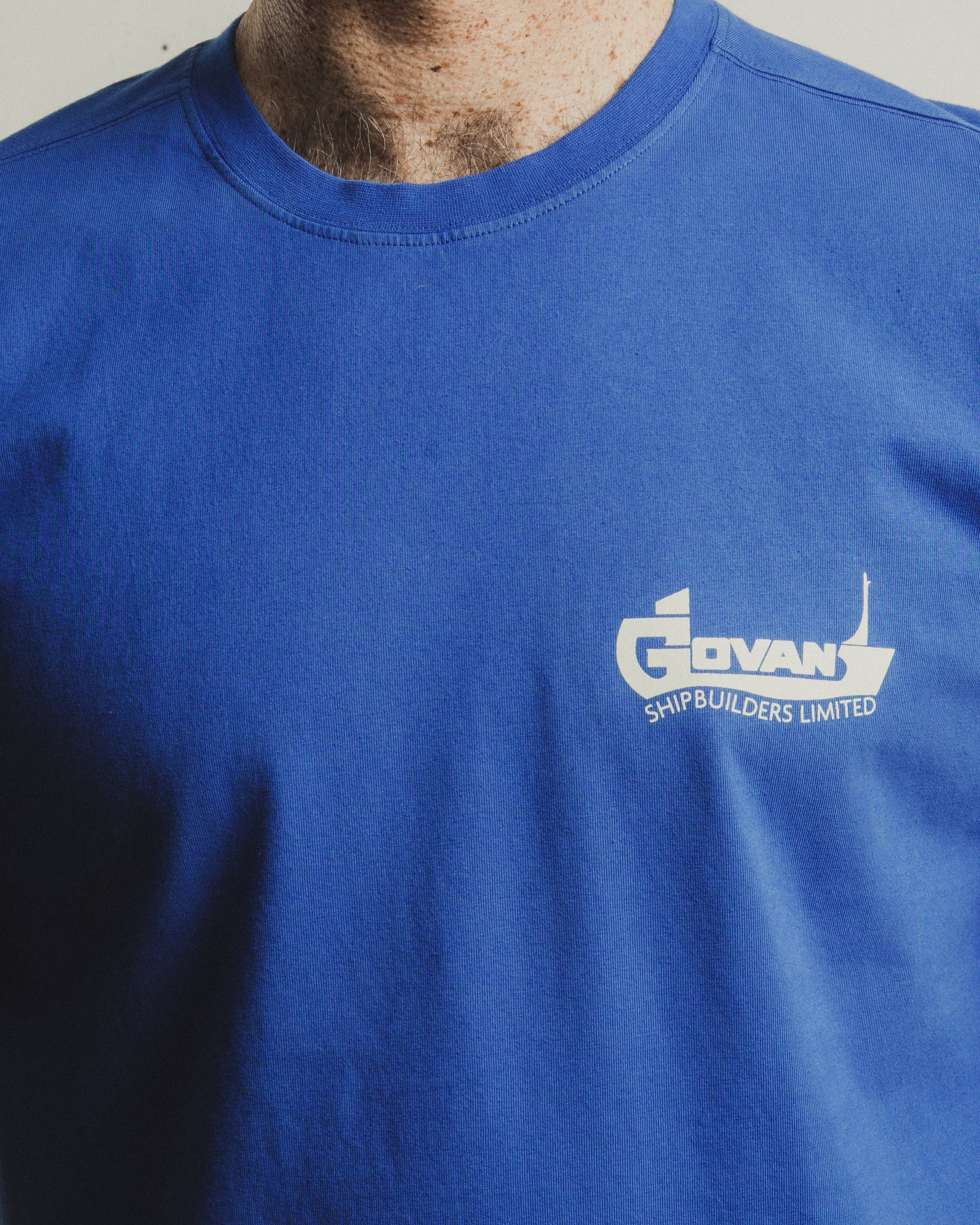 Blue t-shirt with 'Govan Shipbuilders Limited' logo on a plain background