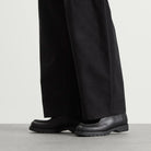 Black Kleman Padror Leather shoes and pants on a neutral background
