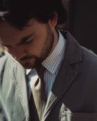 Man wearing a suit and tie with a blurred background