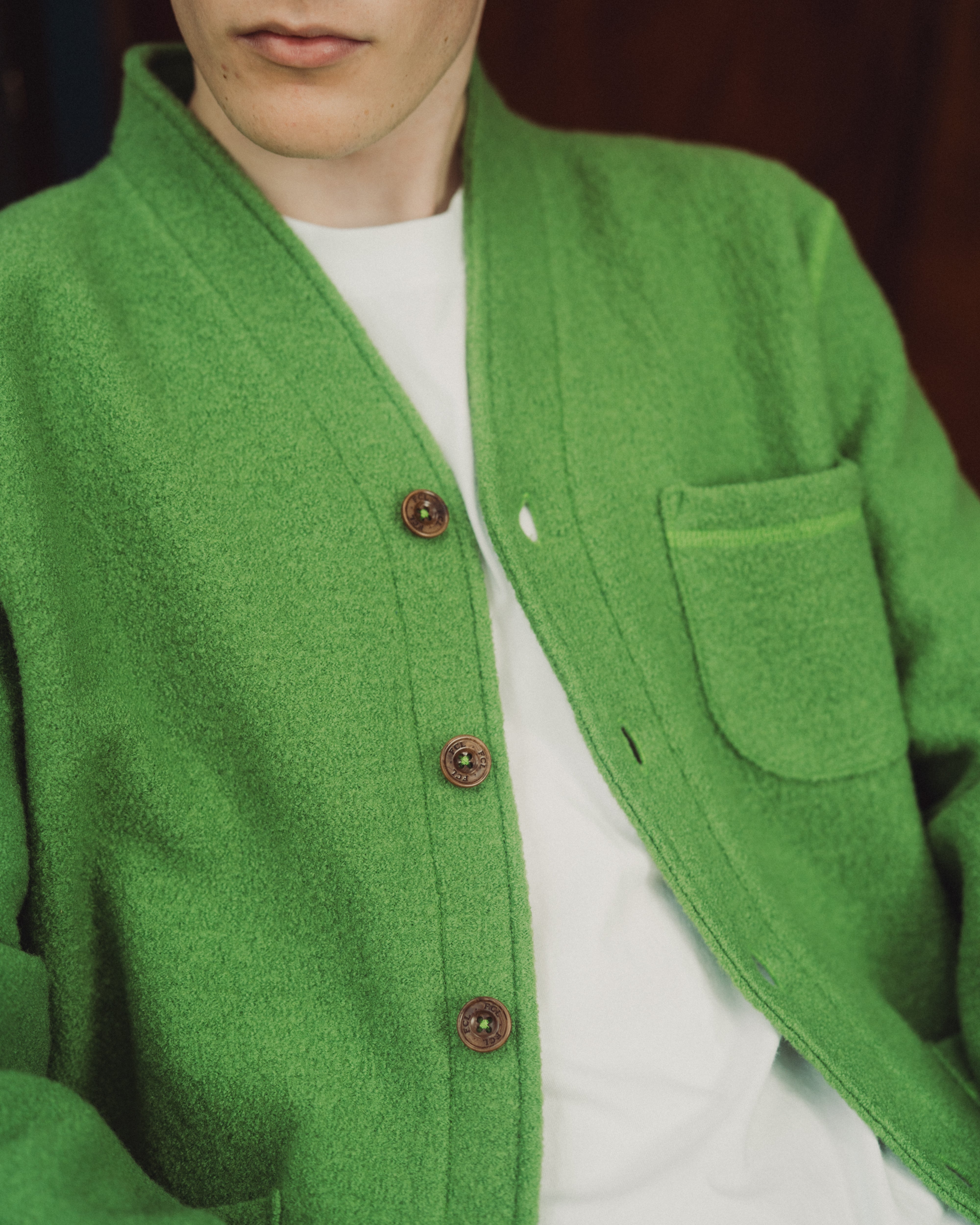 green wool cardigan on top of a white tee