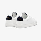 White sneakers with white soles on a white background with navy accents from Zespa