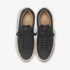 Pair of black Zespa sneakers with white soles on a light gray background