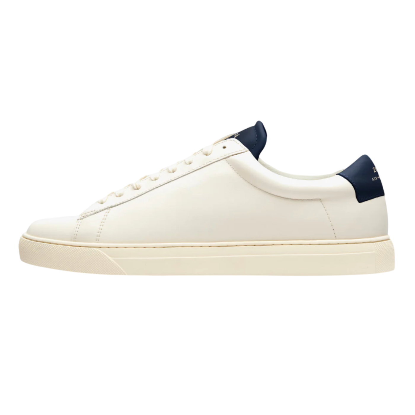 White sneaker with navy accents on a white background